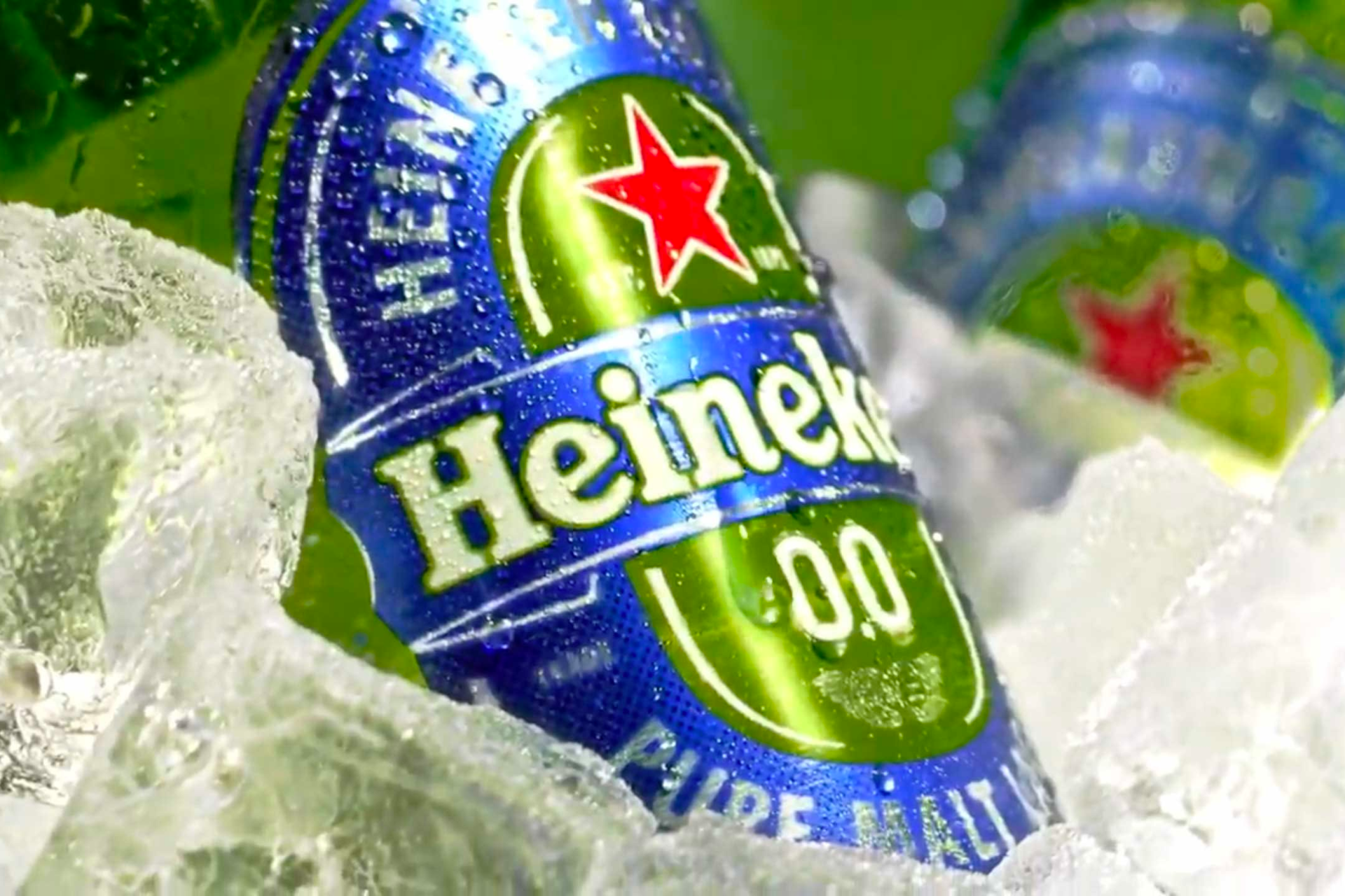 A can of heineken beer is sitting on ice