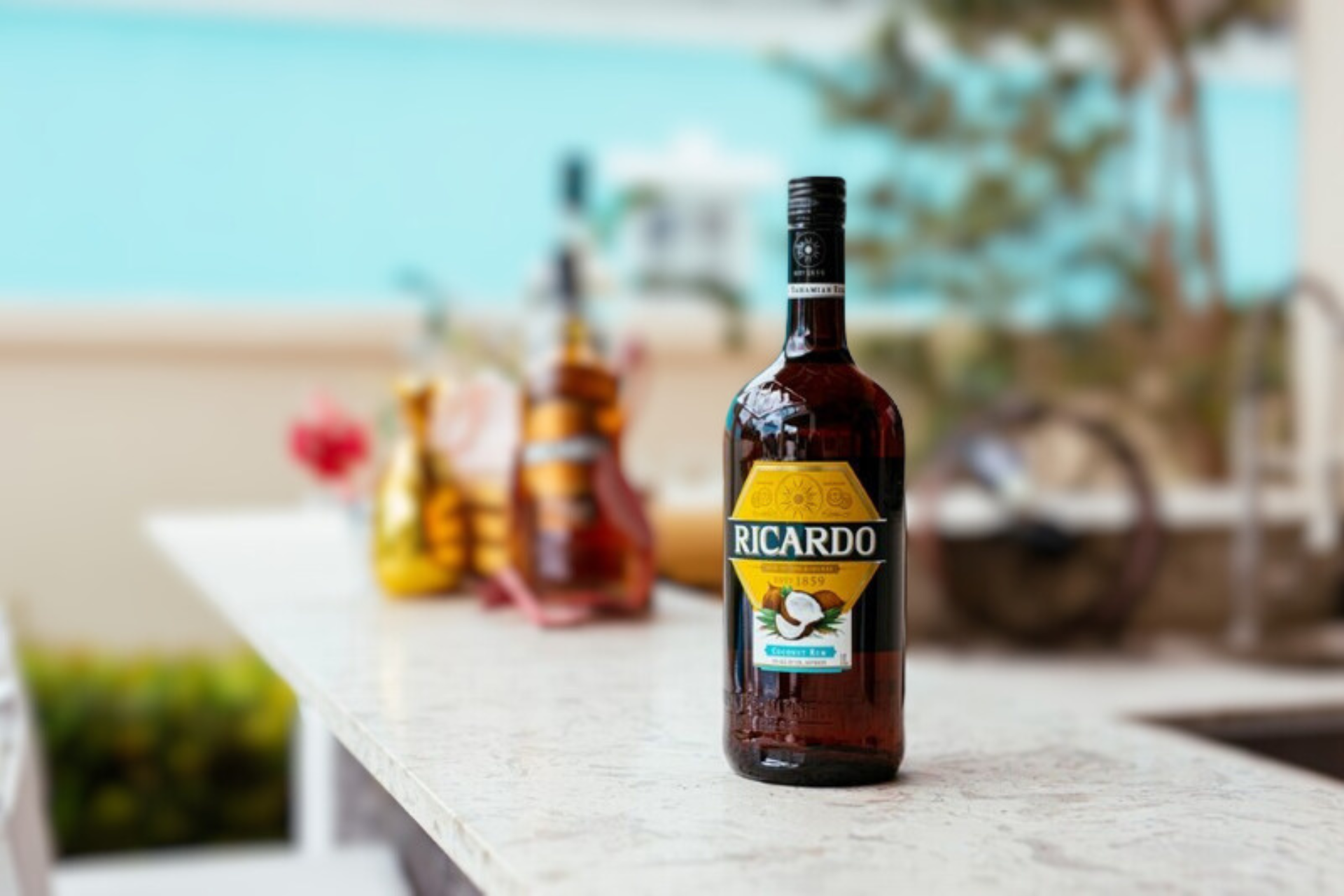A bottle of ricardo liquor is sitting on a counter.