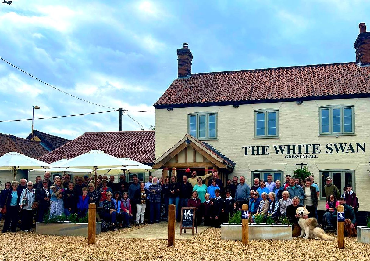 Community of Gressenhall standing outside the community pub called The White Swan