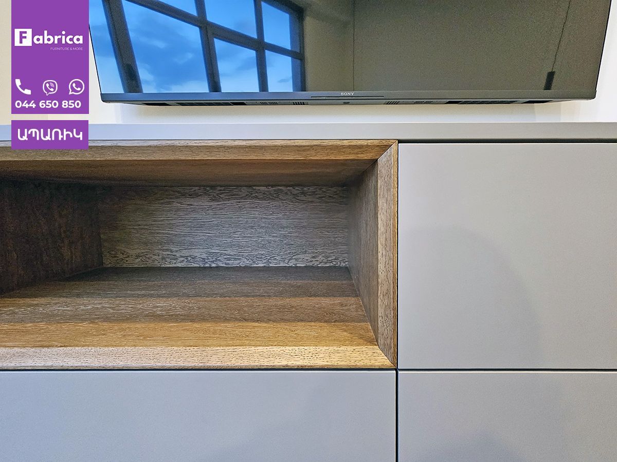 A flat screen tv is sitting on top of a wooden entertainment center.