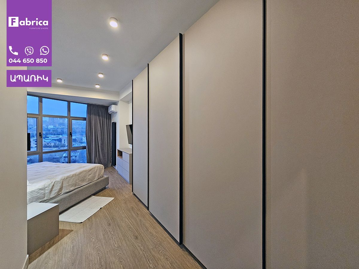 A bedroom with a bed and a purple sign that says fabrica