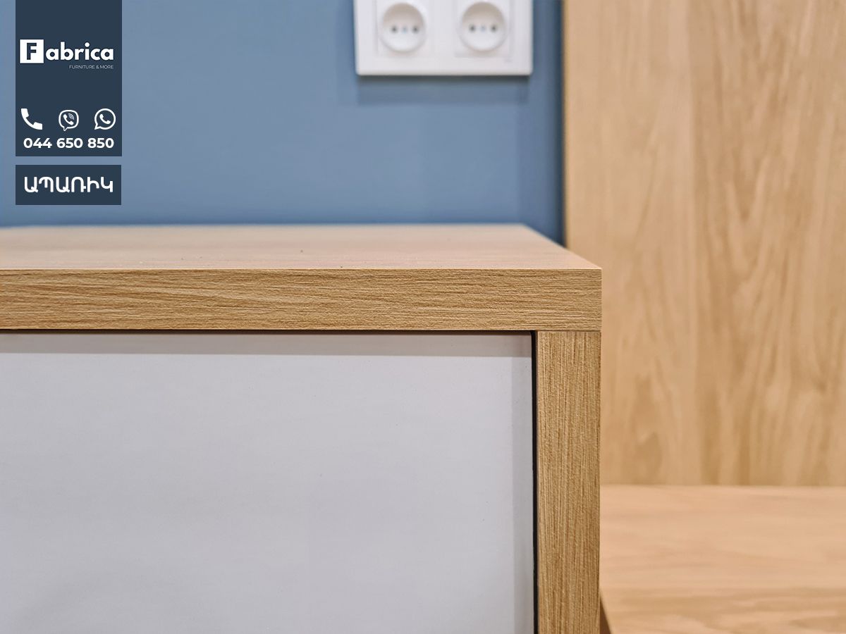 A close up of a wooden cabinet with a white door.