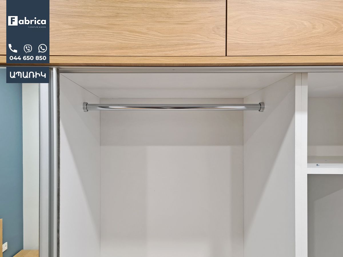 An empty closet with a clothes rack in it.