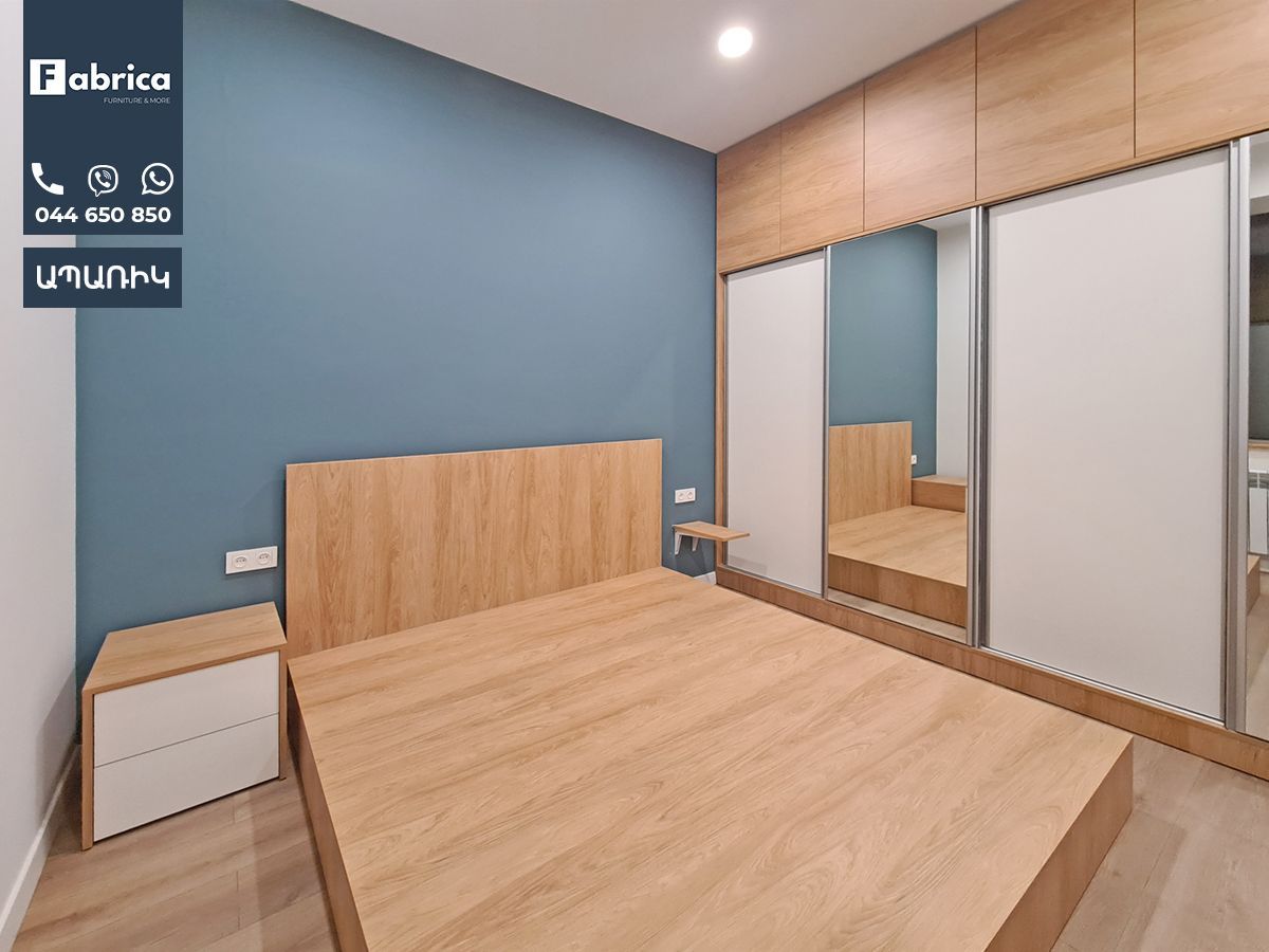 A bedroom with a large bed and sliding glass doors