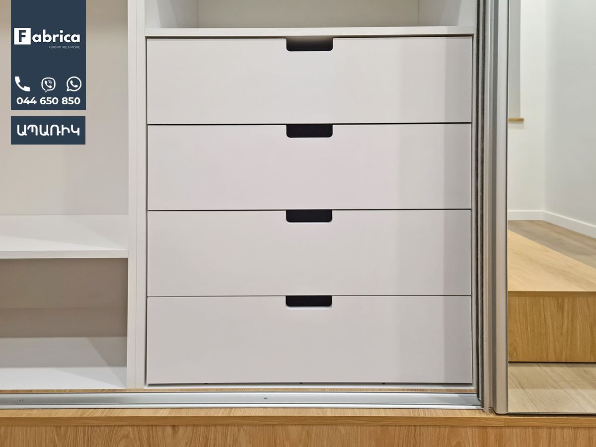 A white dresser with three drawers and a sign that says fabrica