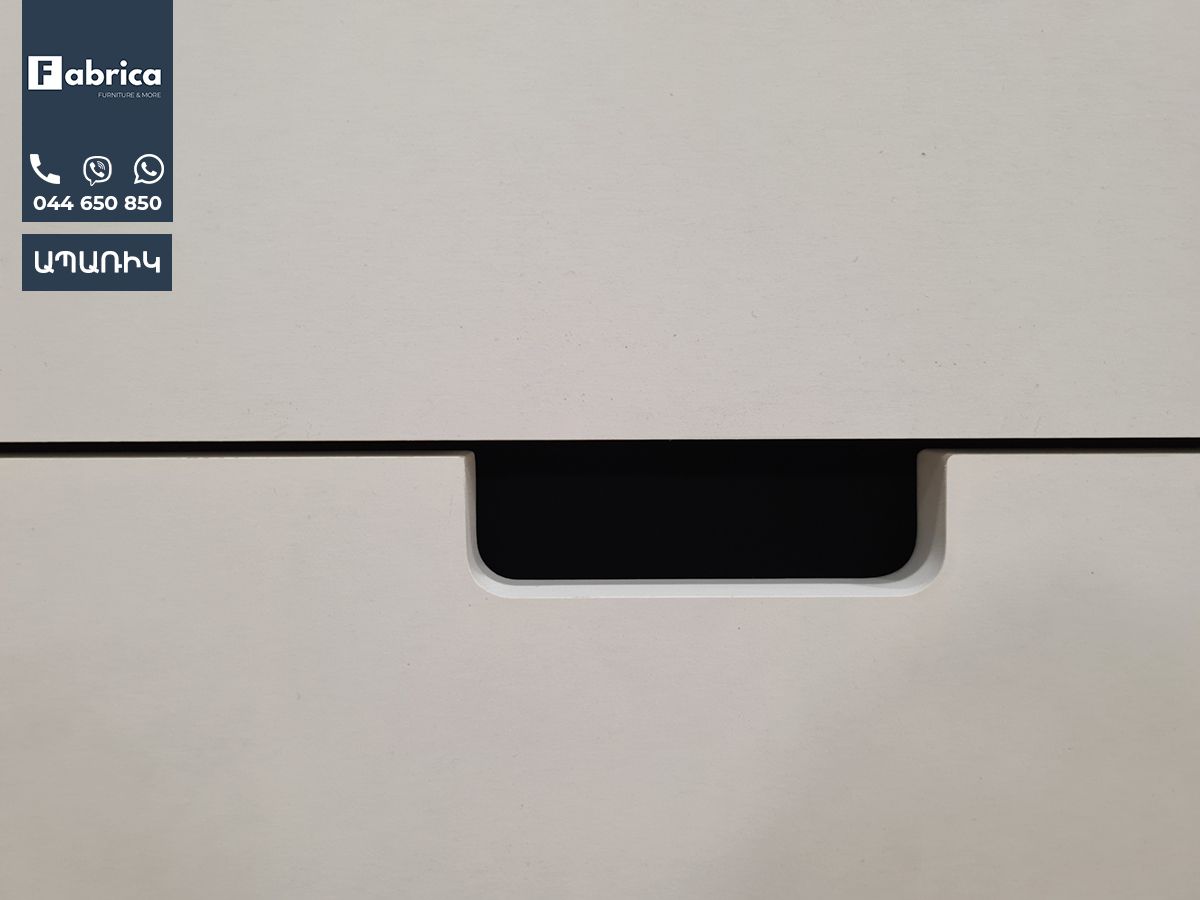 A close up of a white printer with a black handle.