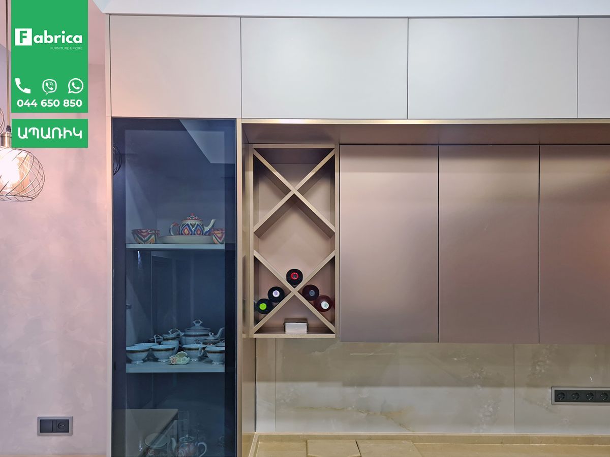 A kitchen with a wine rack and a refrigerator.