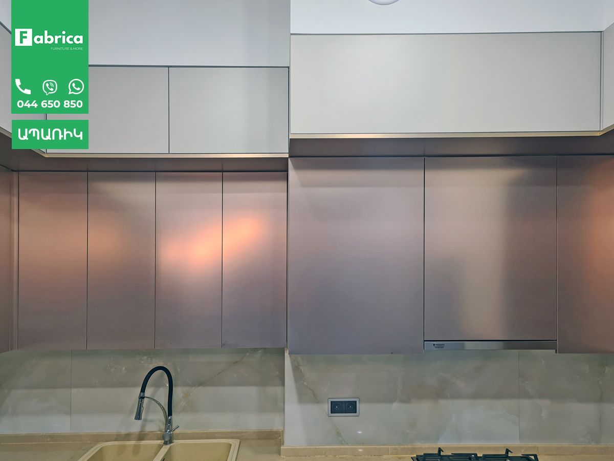 A kitchen with a sink and a stove top oven