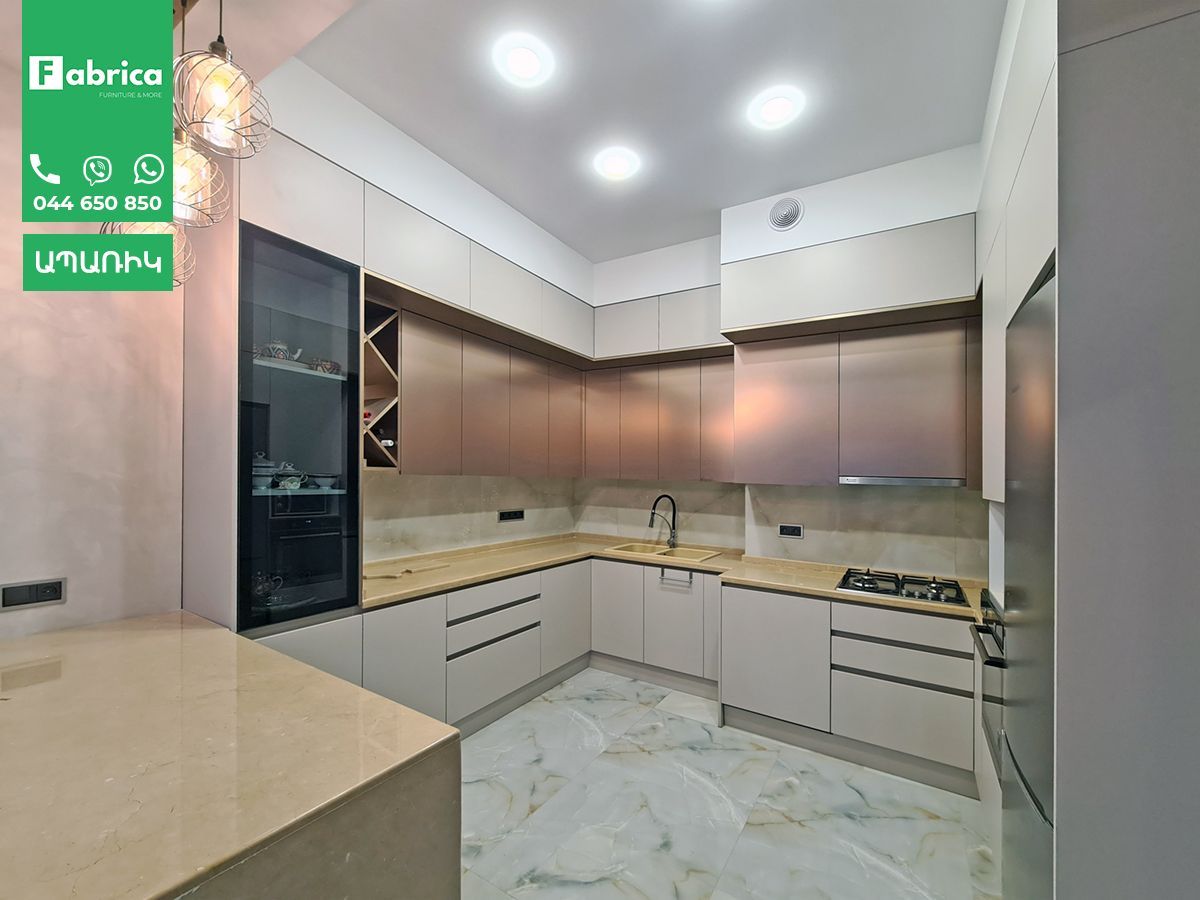 A kitchen with stainless steel cabinets and granite counter tops.
