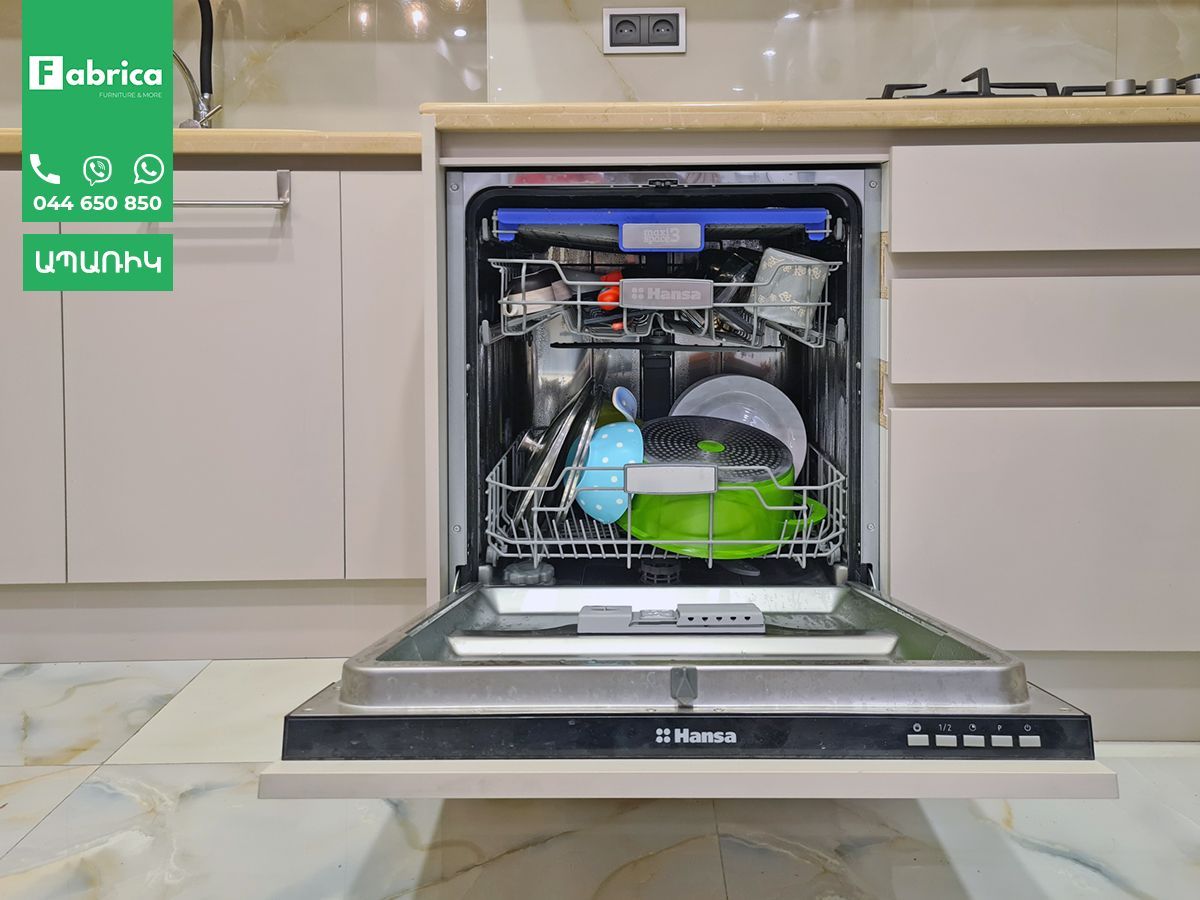 A dishwasher is filled with dishes in a kitchen.