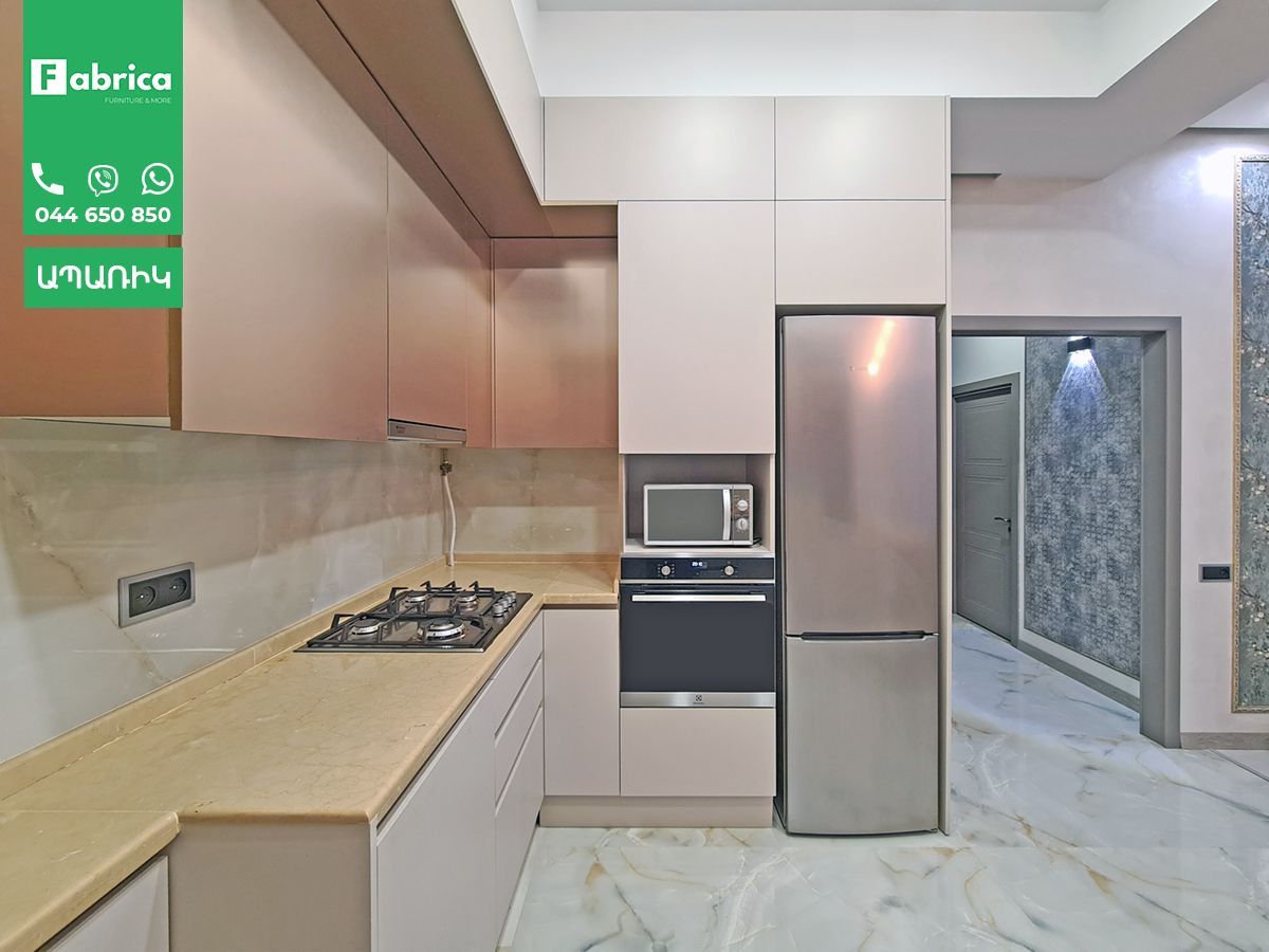 A kitchen with a stove , refrigerator , microwave and oven.