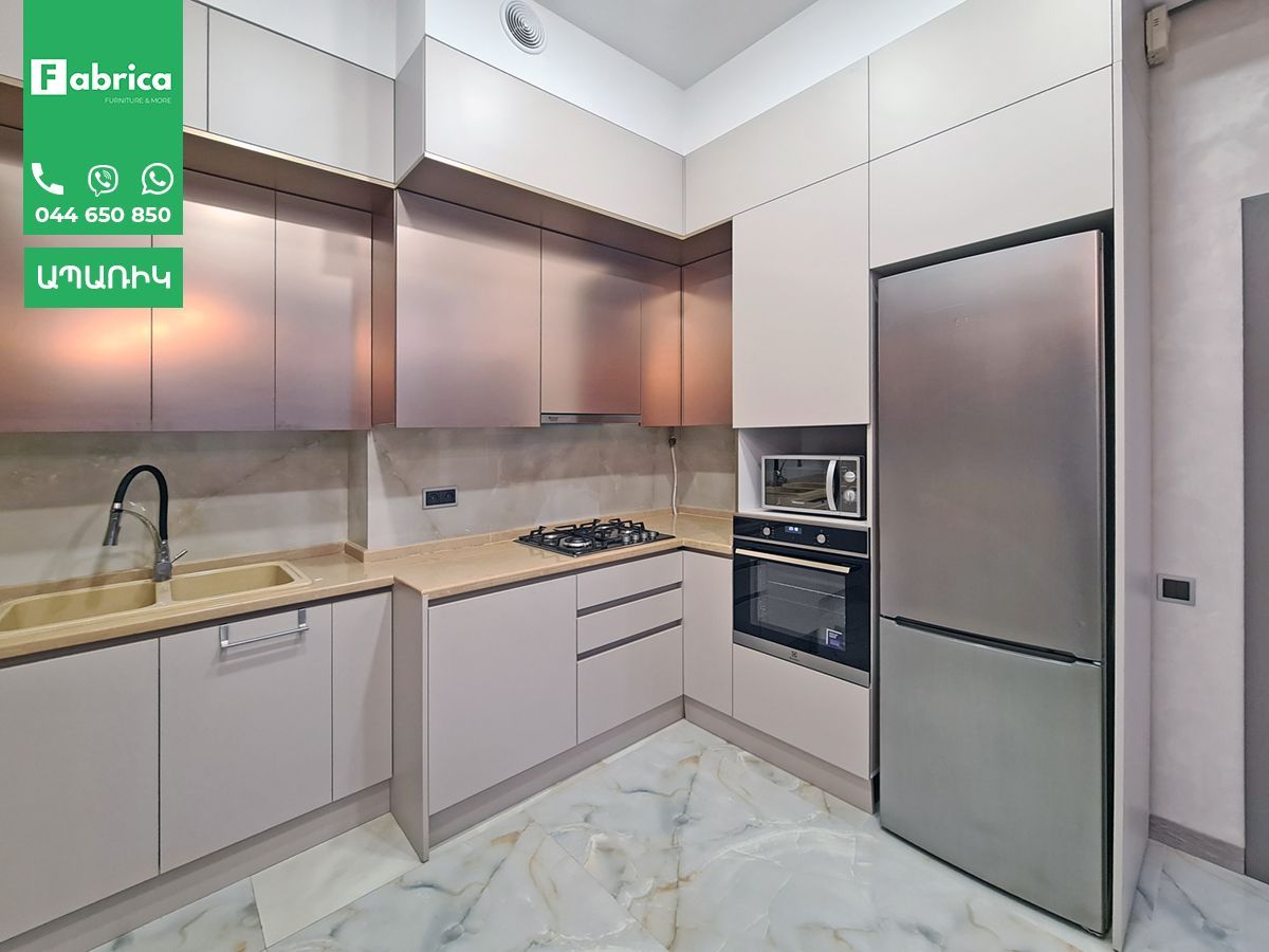 A kitchen with stainless steel appliances and white cabinets