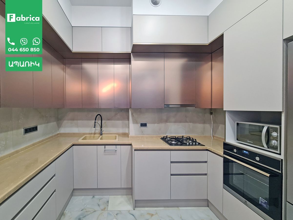 A kitchen with stainless steel appliances and white cabinets