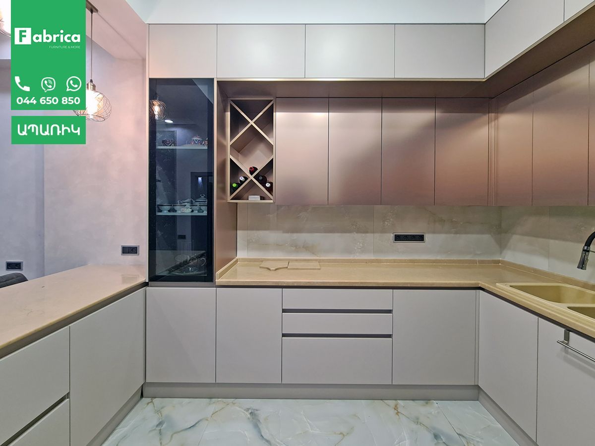 A kitchen with white cabinets and a green sign that says fabrice