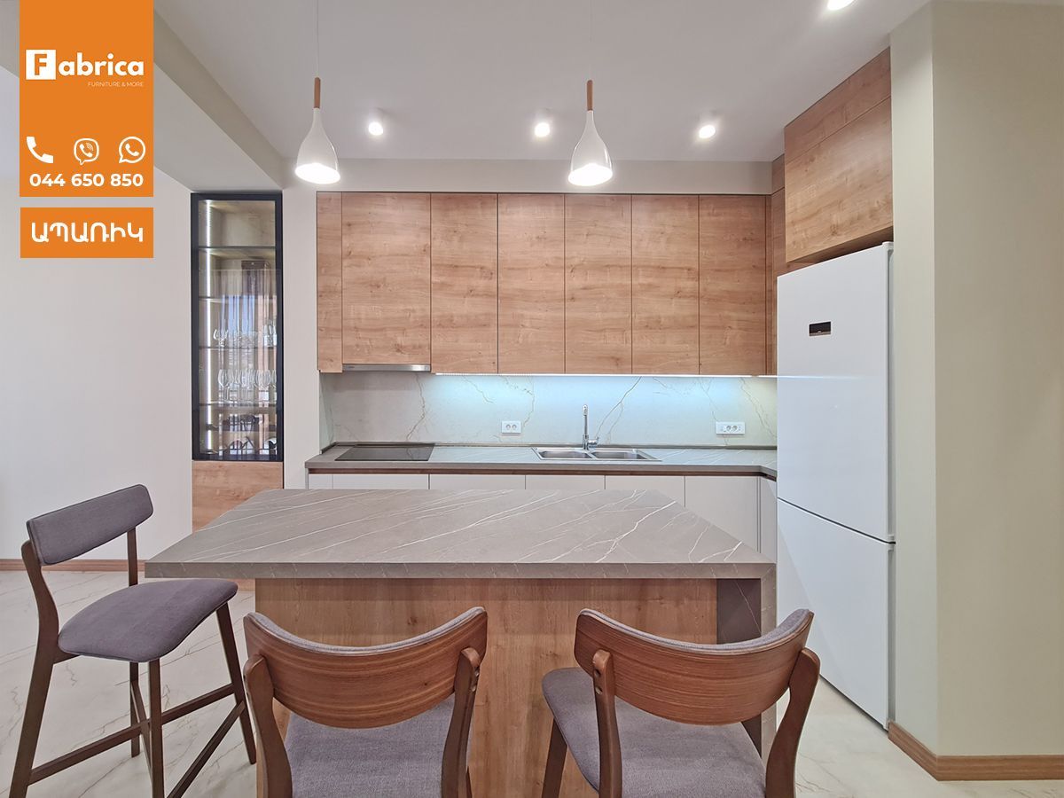 A kitchen with wooden cabinets and a white refrigerator