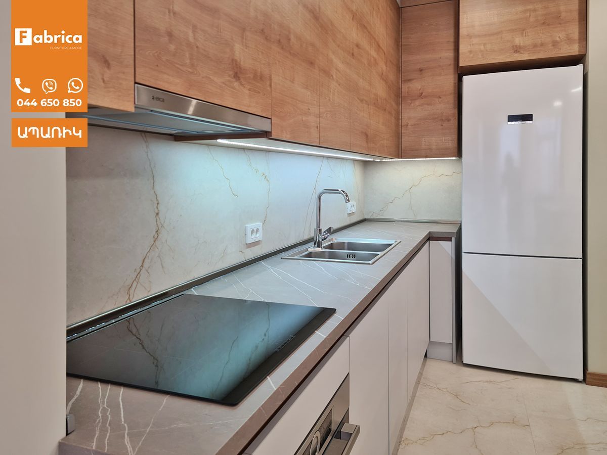 A kitchen with wooden cabinets and a white refrigerator