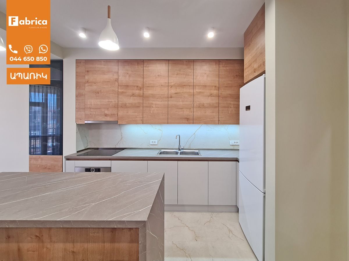 A kitchen with wooden cabinets and a white refrigerator.