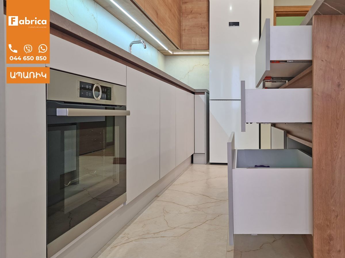 A kitchen with stainless steel appliances and white cabinets