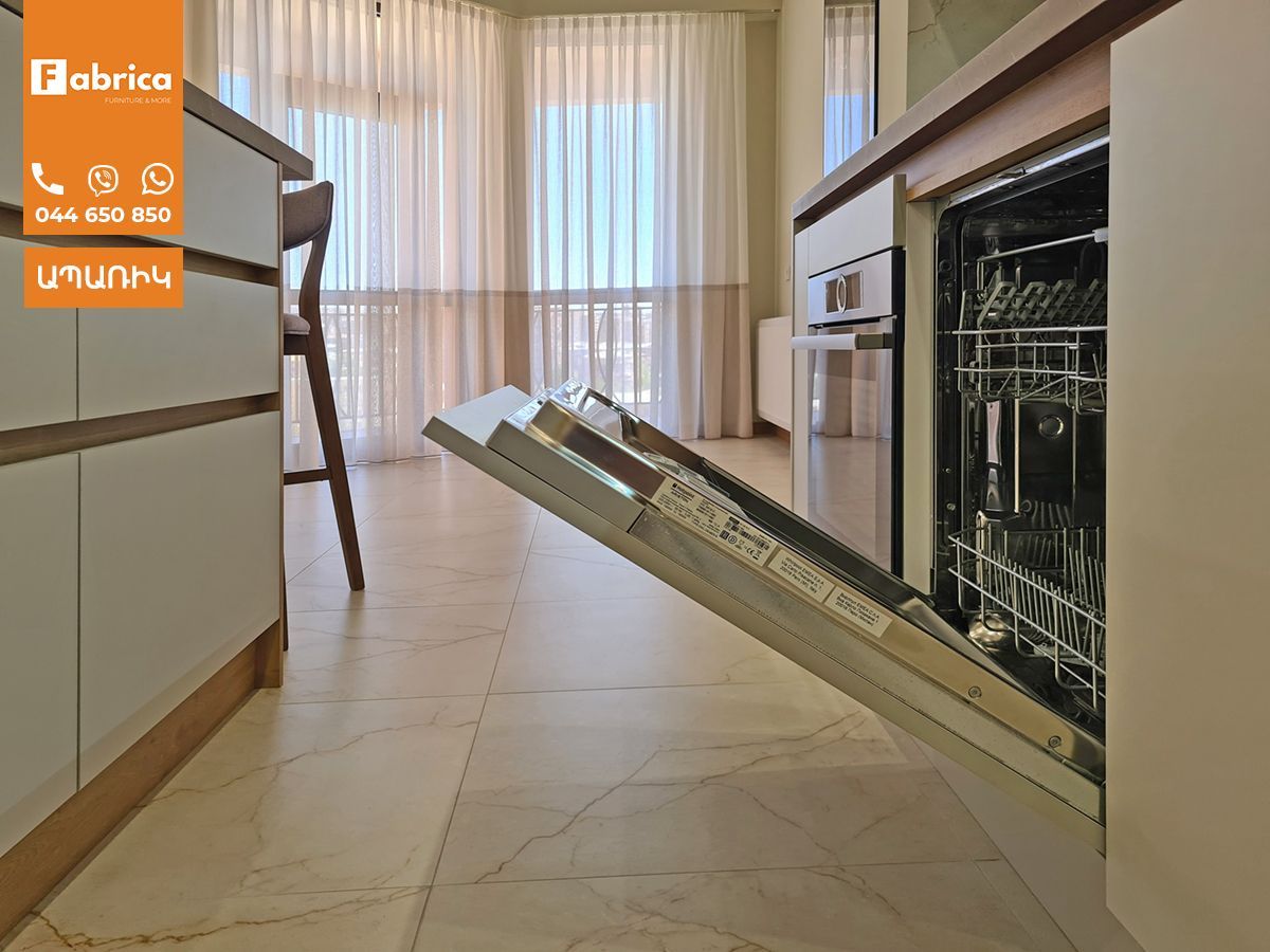 A dishwasher is open in a kitchen with the door open.