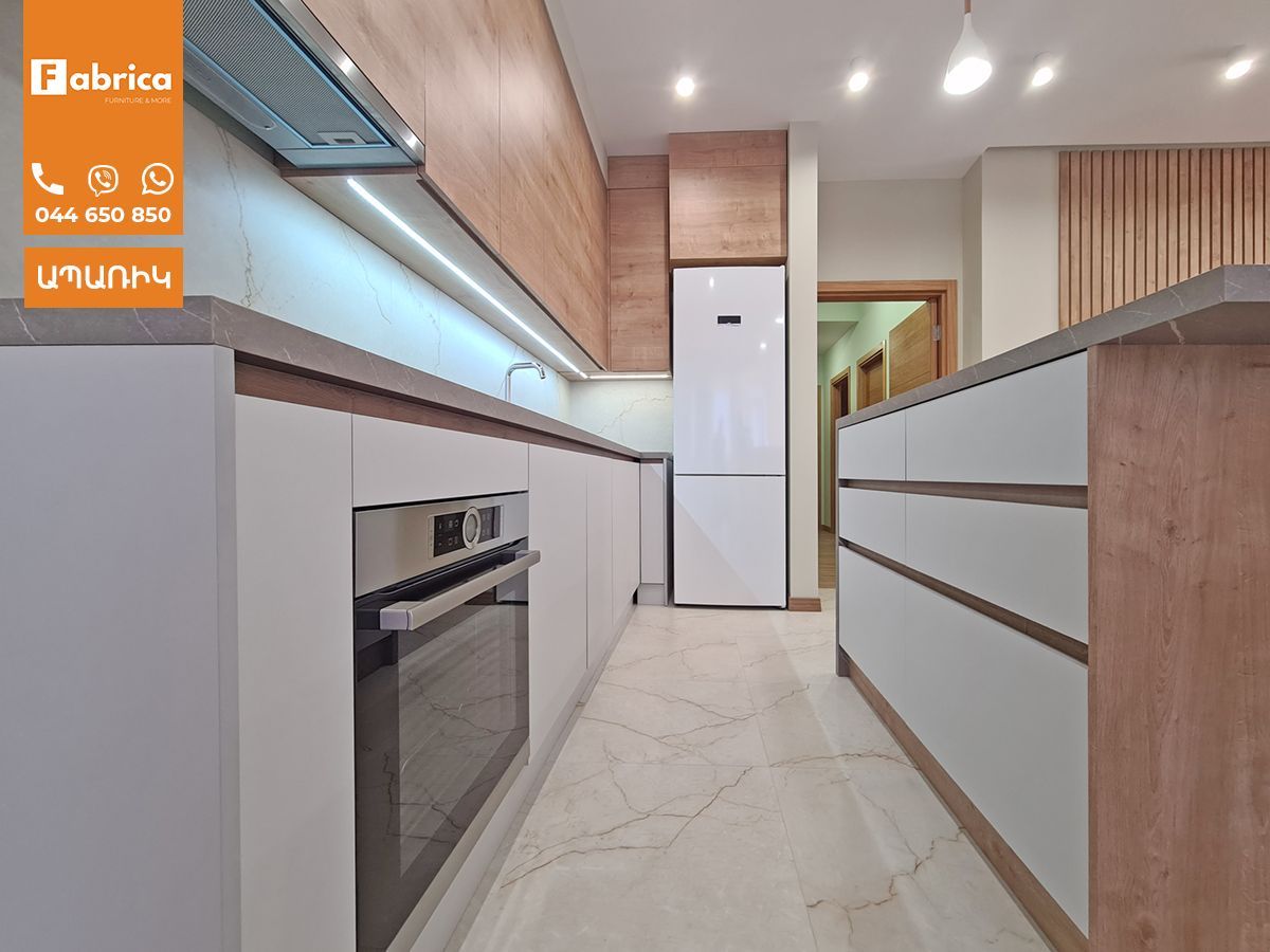 A kitchen with wooden cabinets and a white refrigerator