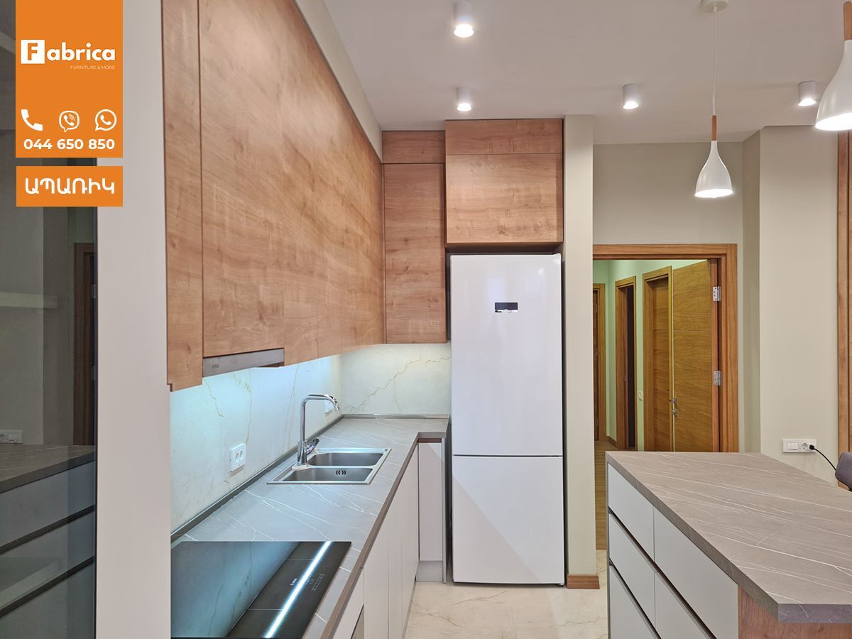 A kitchen with wooden cabinets and a white refrigerator