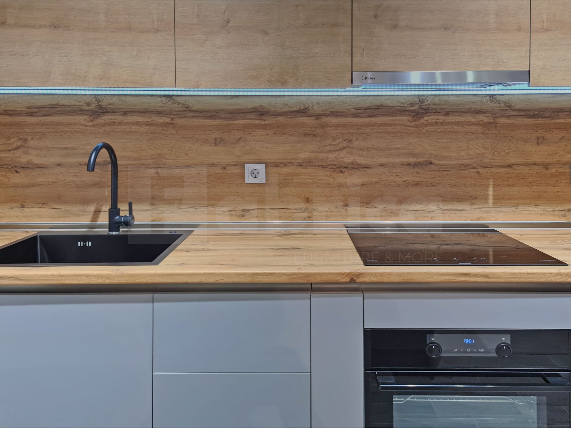 A kitchen with a sink , stove , and oven.