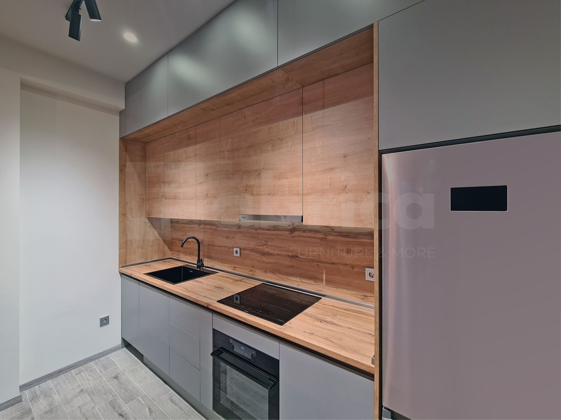 A kitchen with a sink , stove , refrigerator and microwave.