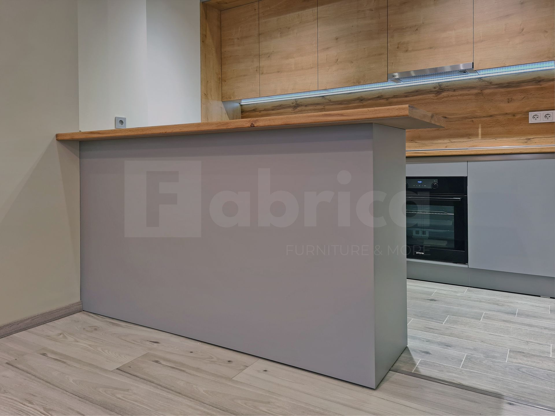A kitchen with wooden cabinets and a wooden counter top.