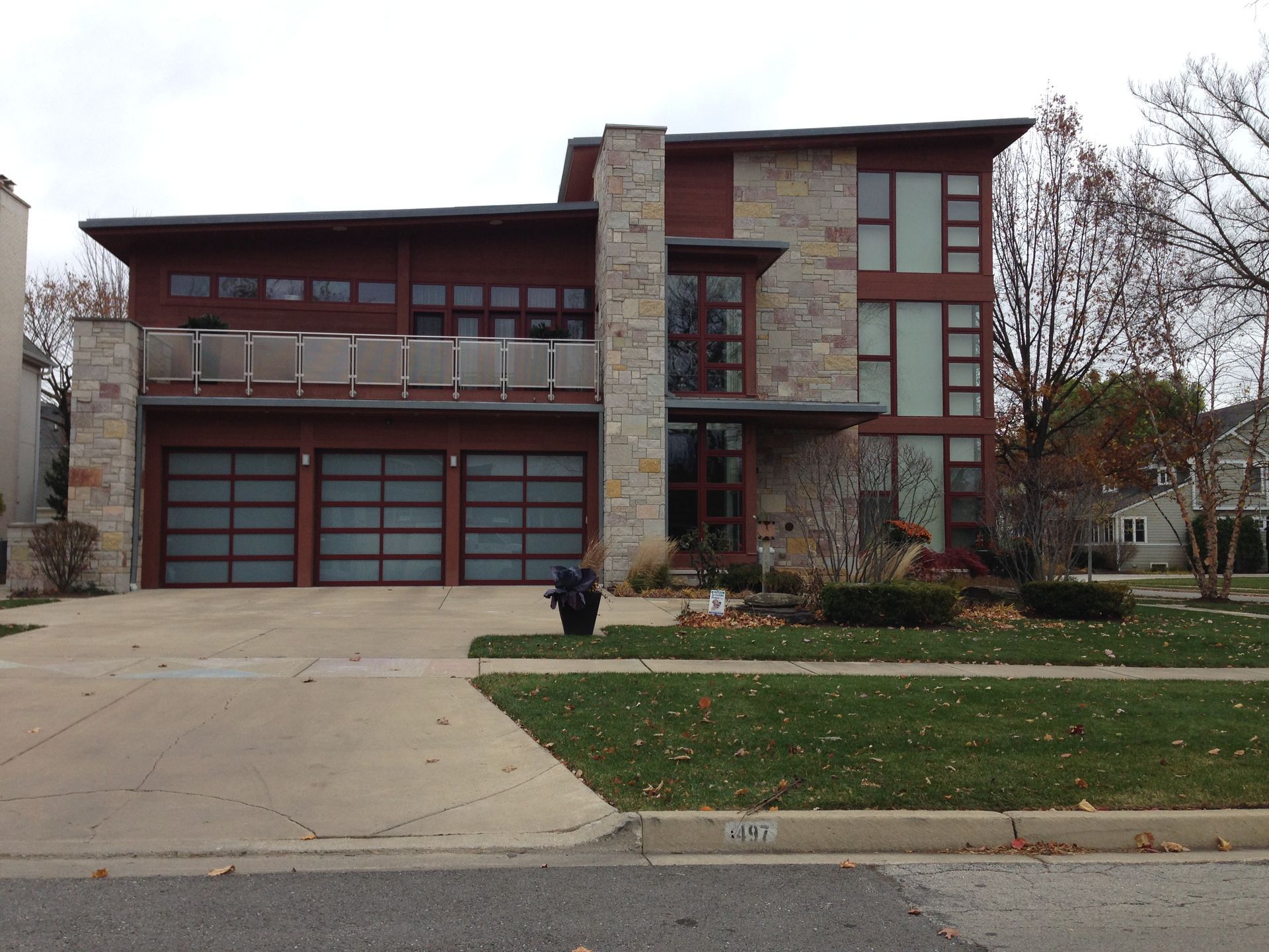 Empty, unfinished garage interior with exposed wooden framing and closed garage door.