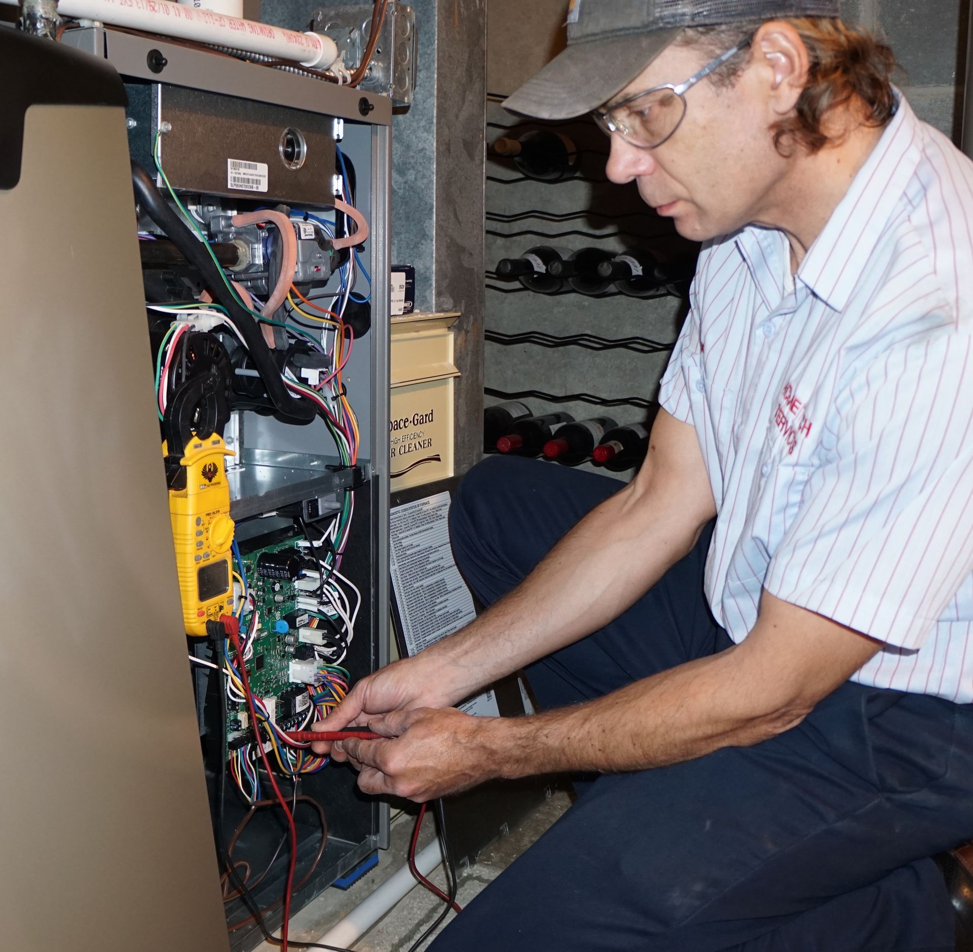Person replacing an air filter in a ceiling vent.
