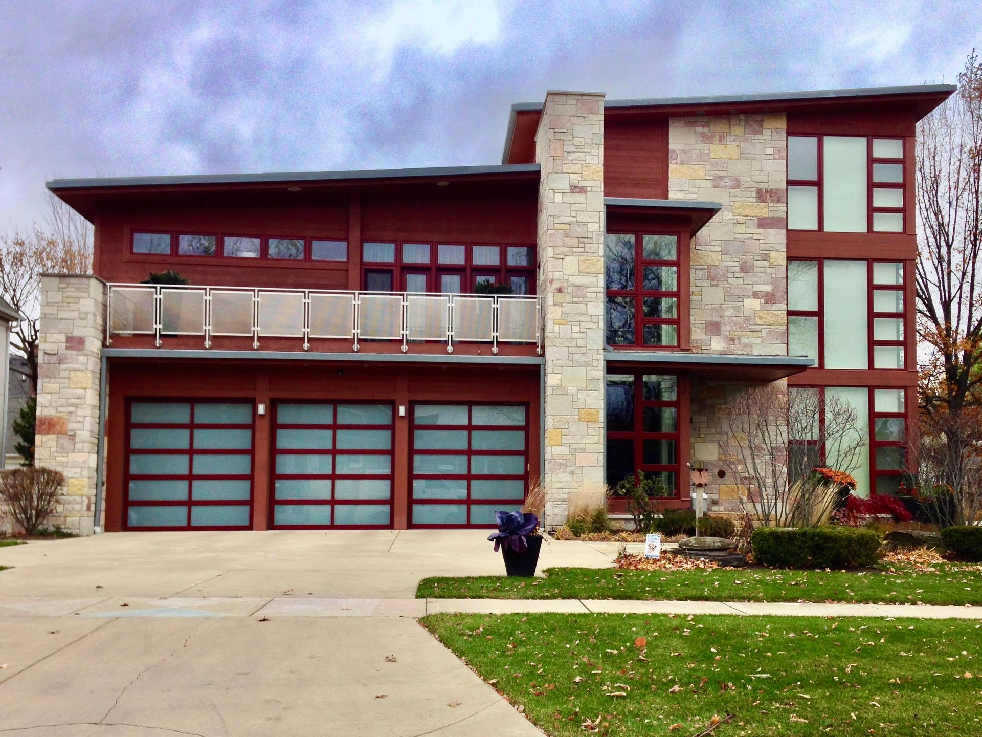 Empty, unfinished garage interior with exposed wooden framing and closed garage door.