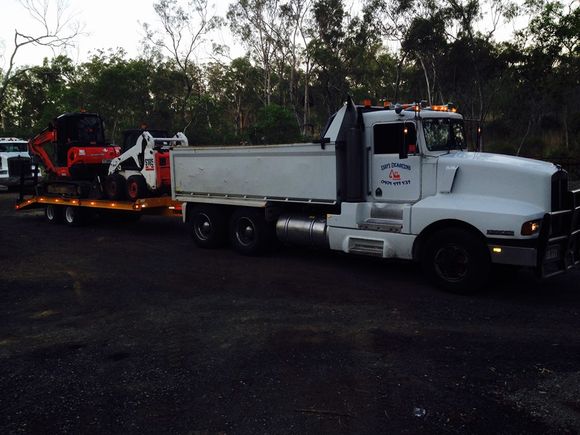 Truck loaded with Equipment  — Earthmoving Services  in Gladstone, QLD
