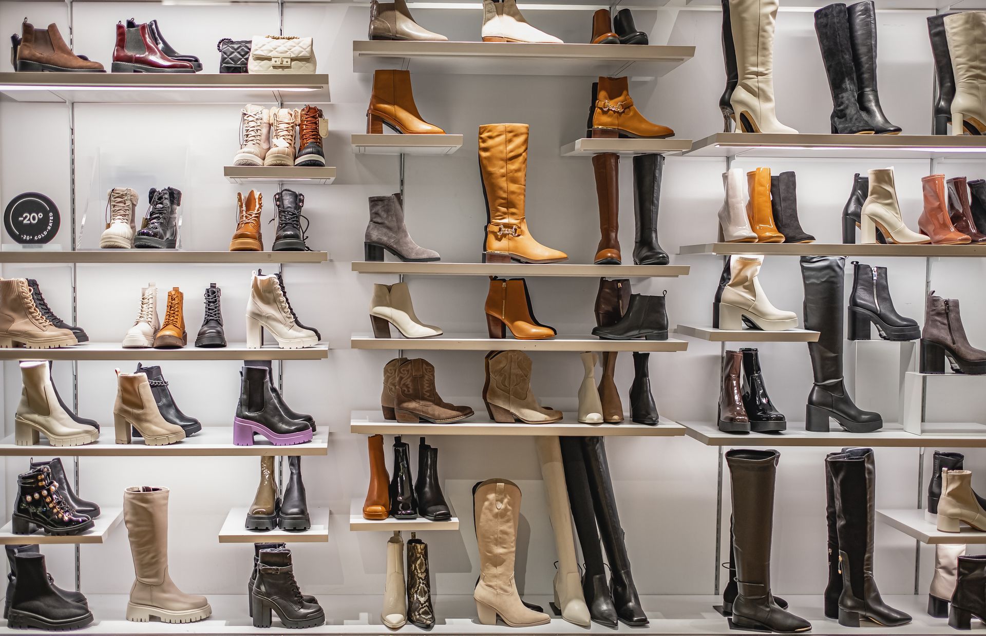 A shoe store filled with lots of different types of shoes and boots.