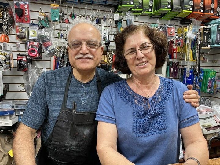 A man and a woman are posing for a picture in a hardware store.