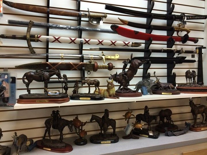A display of swords and statues of horses