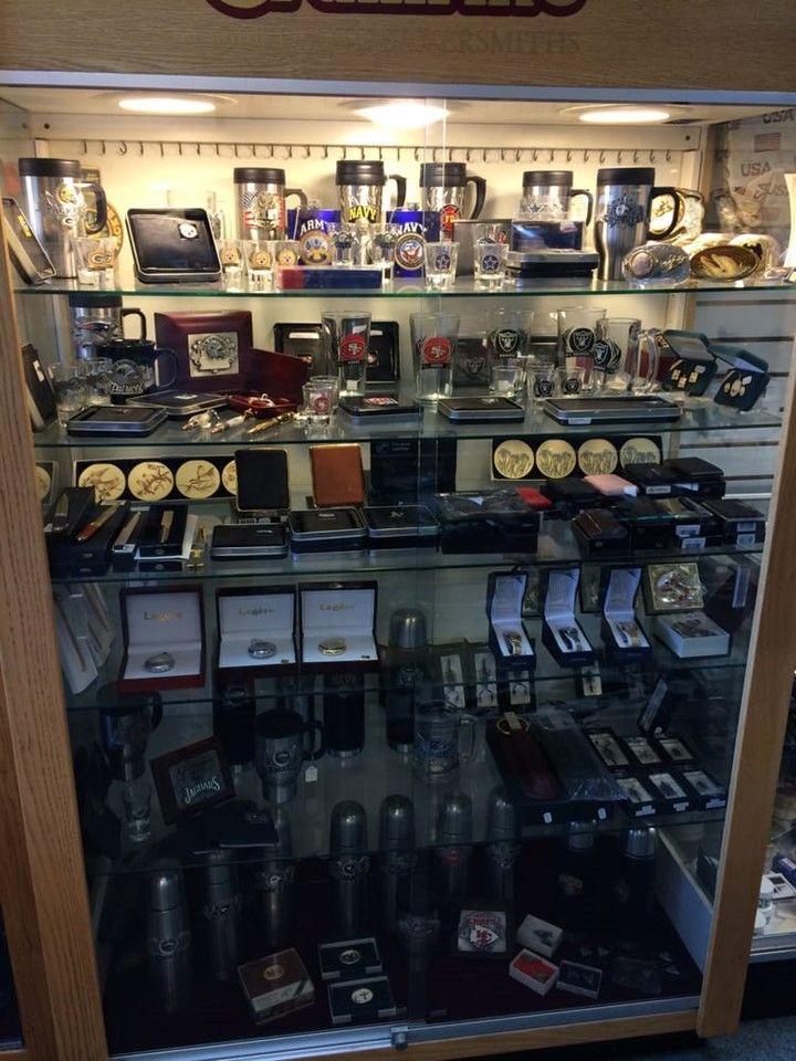 A glass display case filled with a variety of items