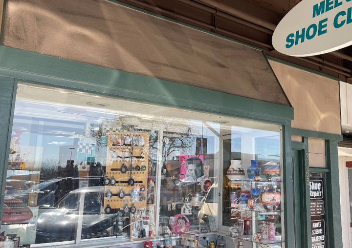 A store front with a sign that says shoe cleaner on it.