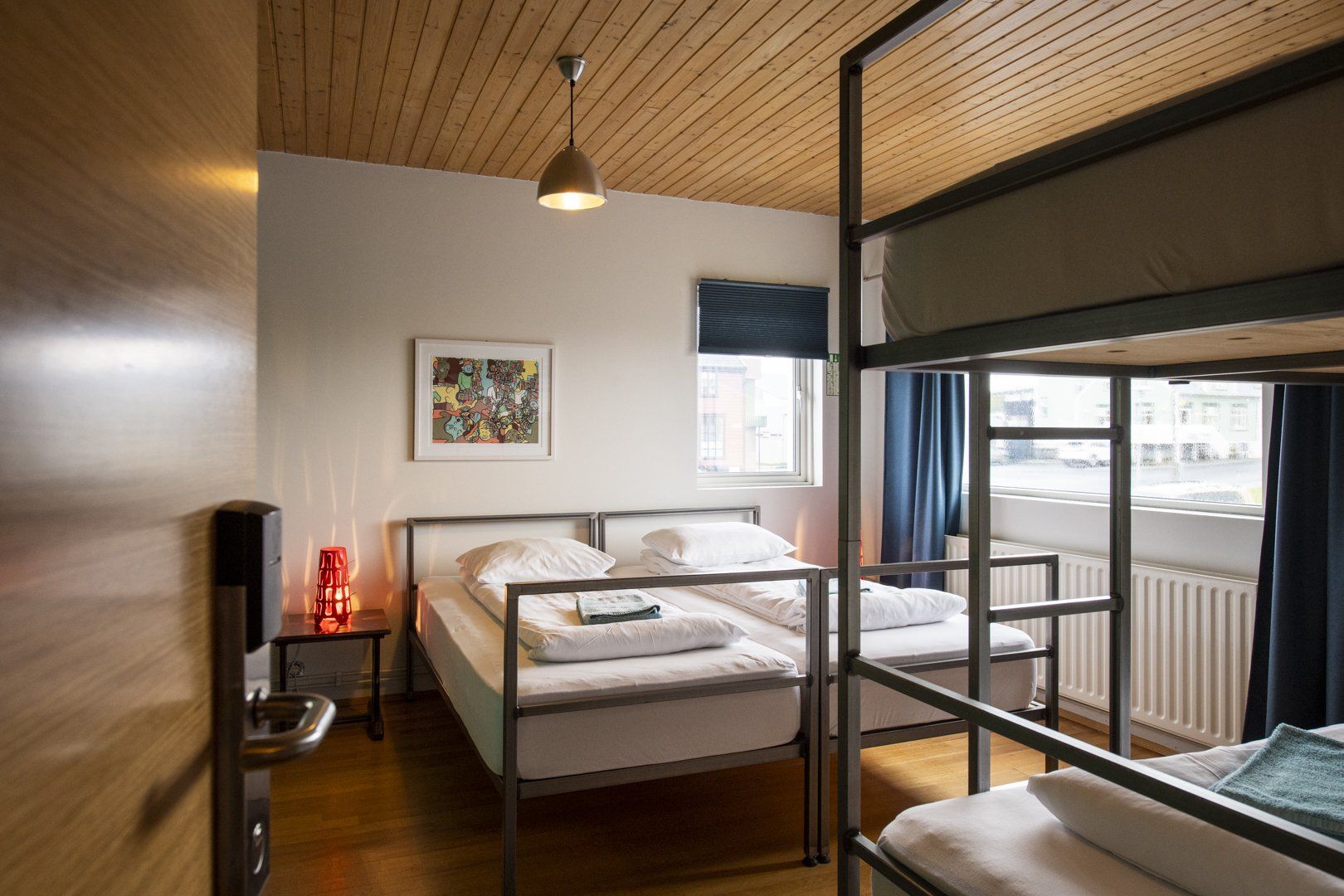 A bedroom with two beds and a bunk bed.