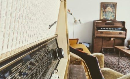 A radio in a living room next to a piano
