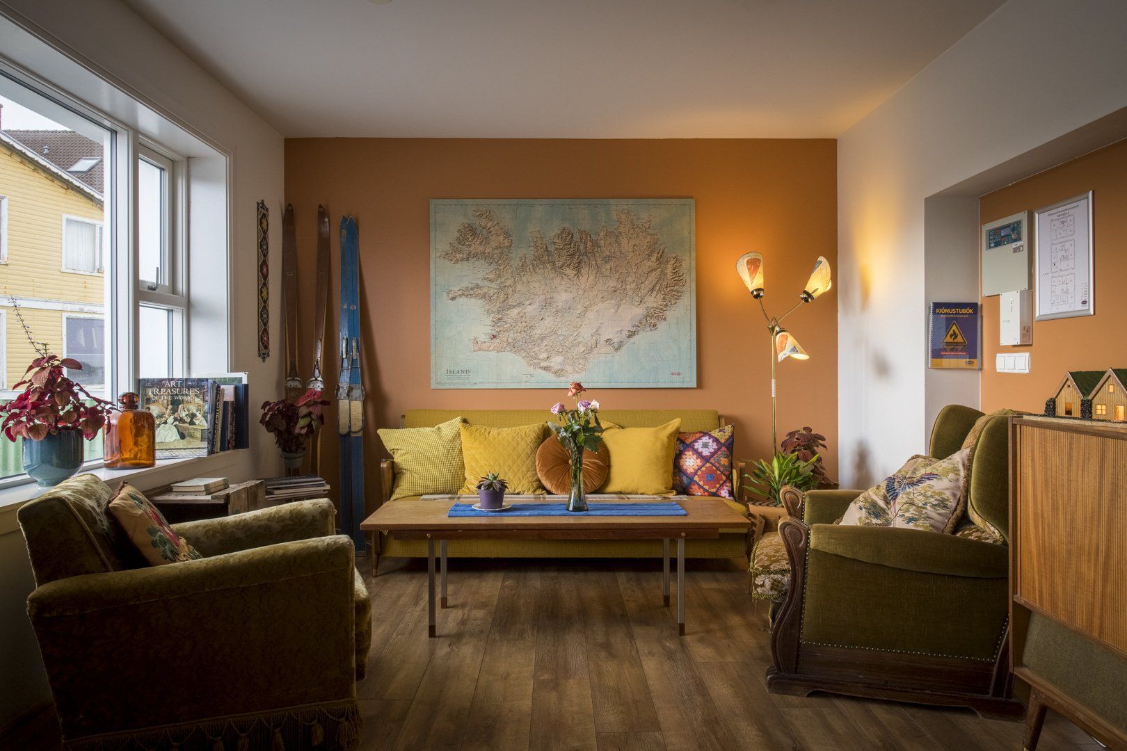 There is a map of iceland on the wall above the couch in the living room.