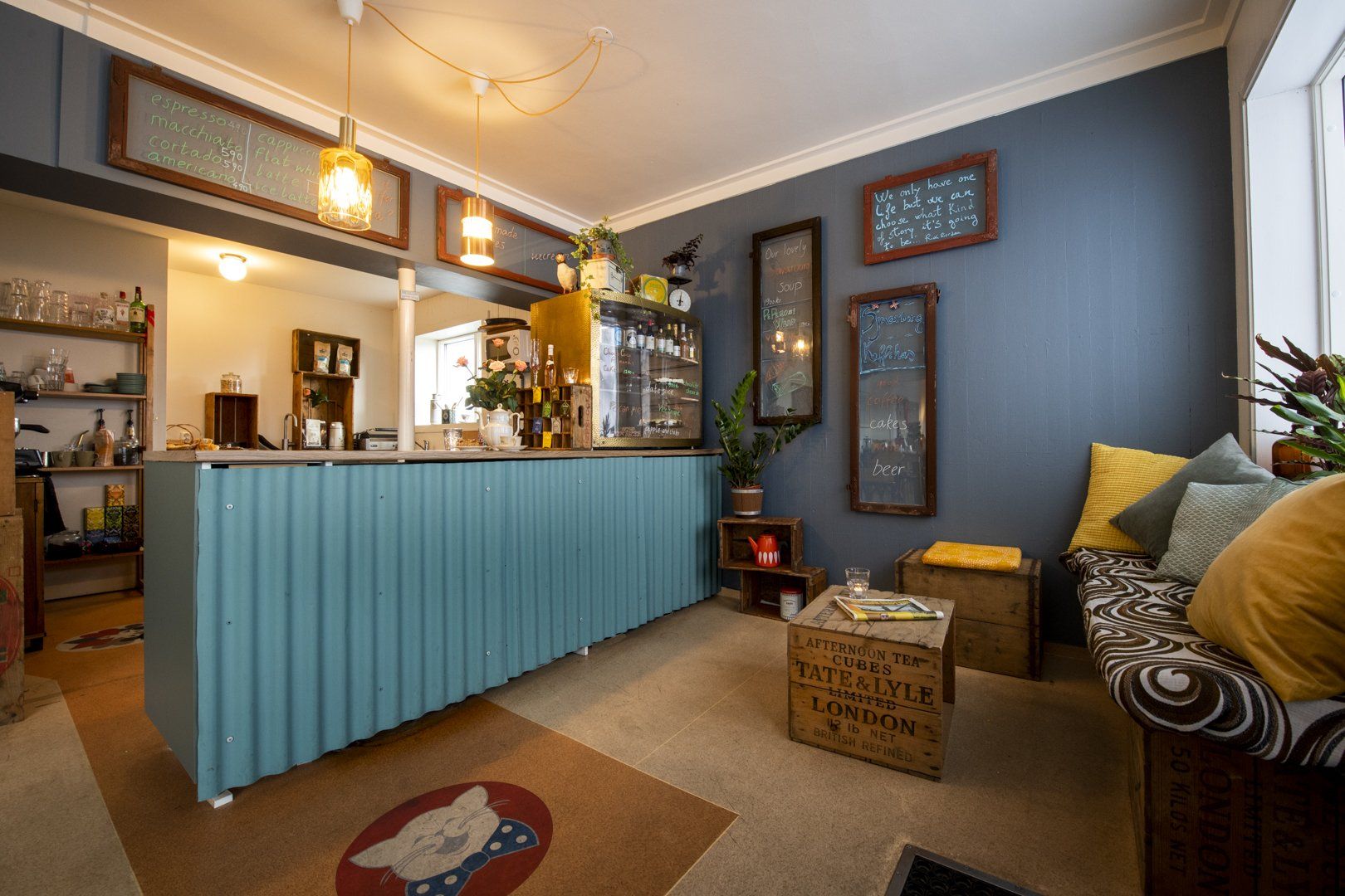 A living room with a blue counter and a couch.