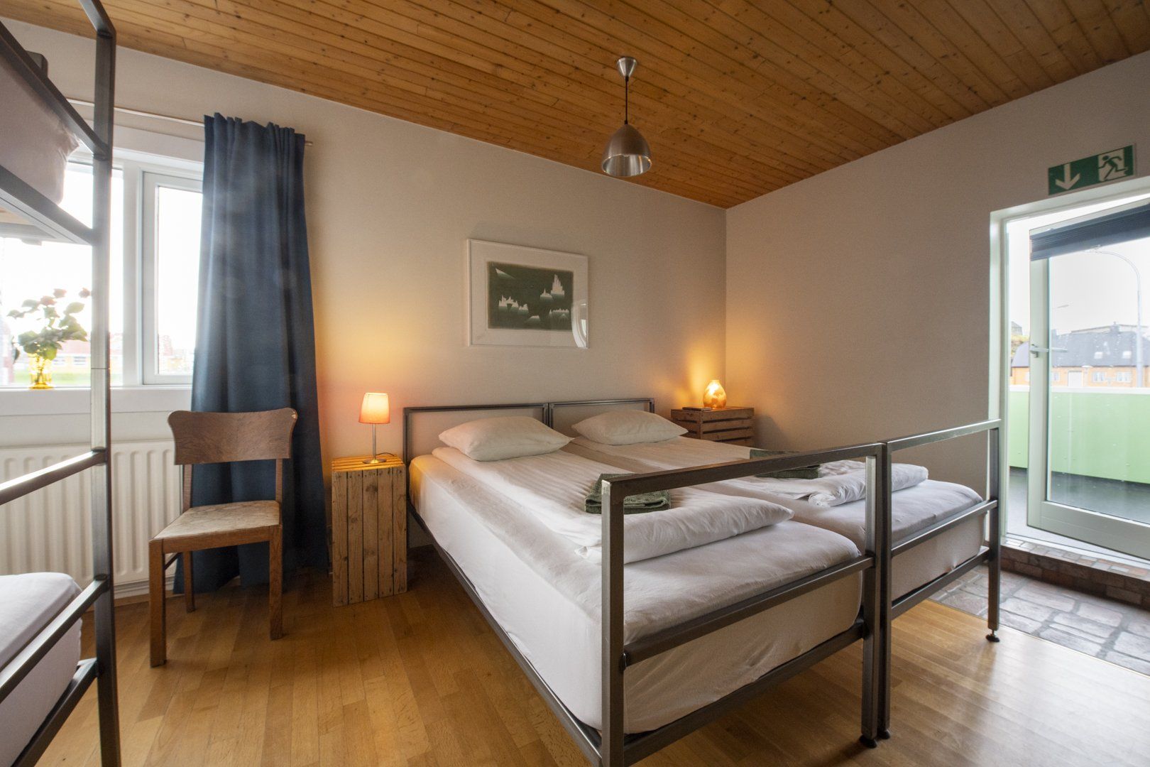 A bedroom with two beds and a bunk bed.