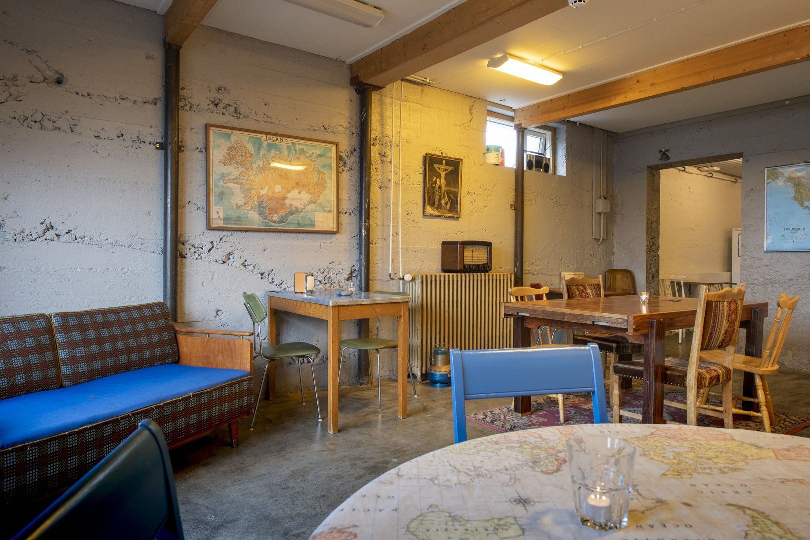 A room with tables and chairs and a map on the wall