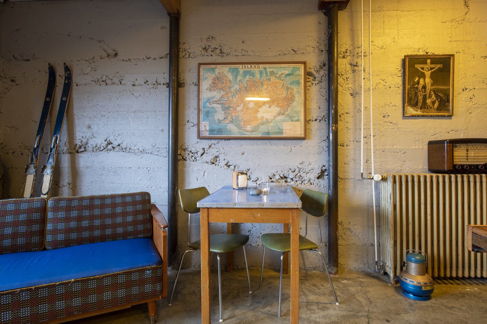 A room with a table and chairs and a map on the wall.