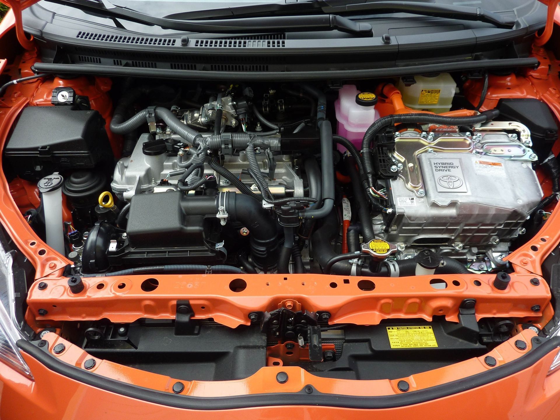 Under the hood of orange car | C&D Automotive