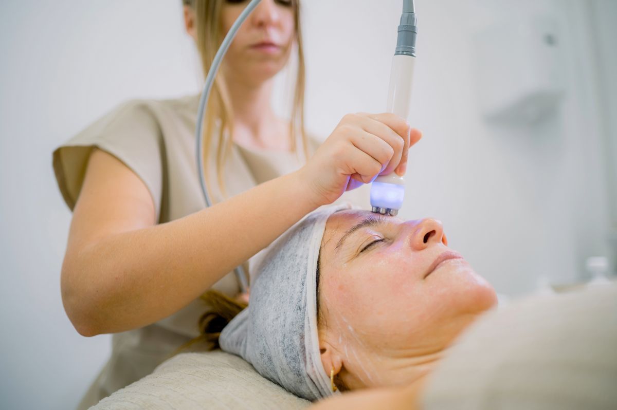 Woman receiving professional facial treatment at a spa, representing first facial experience in Albuquerque.