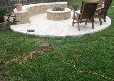 There is a fire pit in the middle of the backyard.