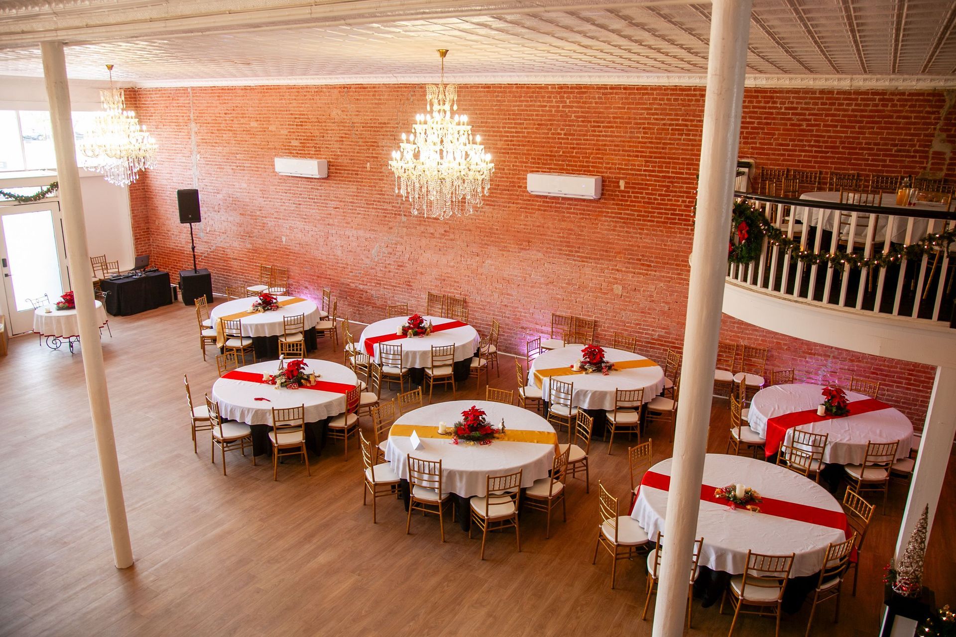 a large room filled with tables and chairs and a chandelier .