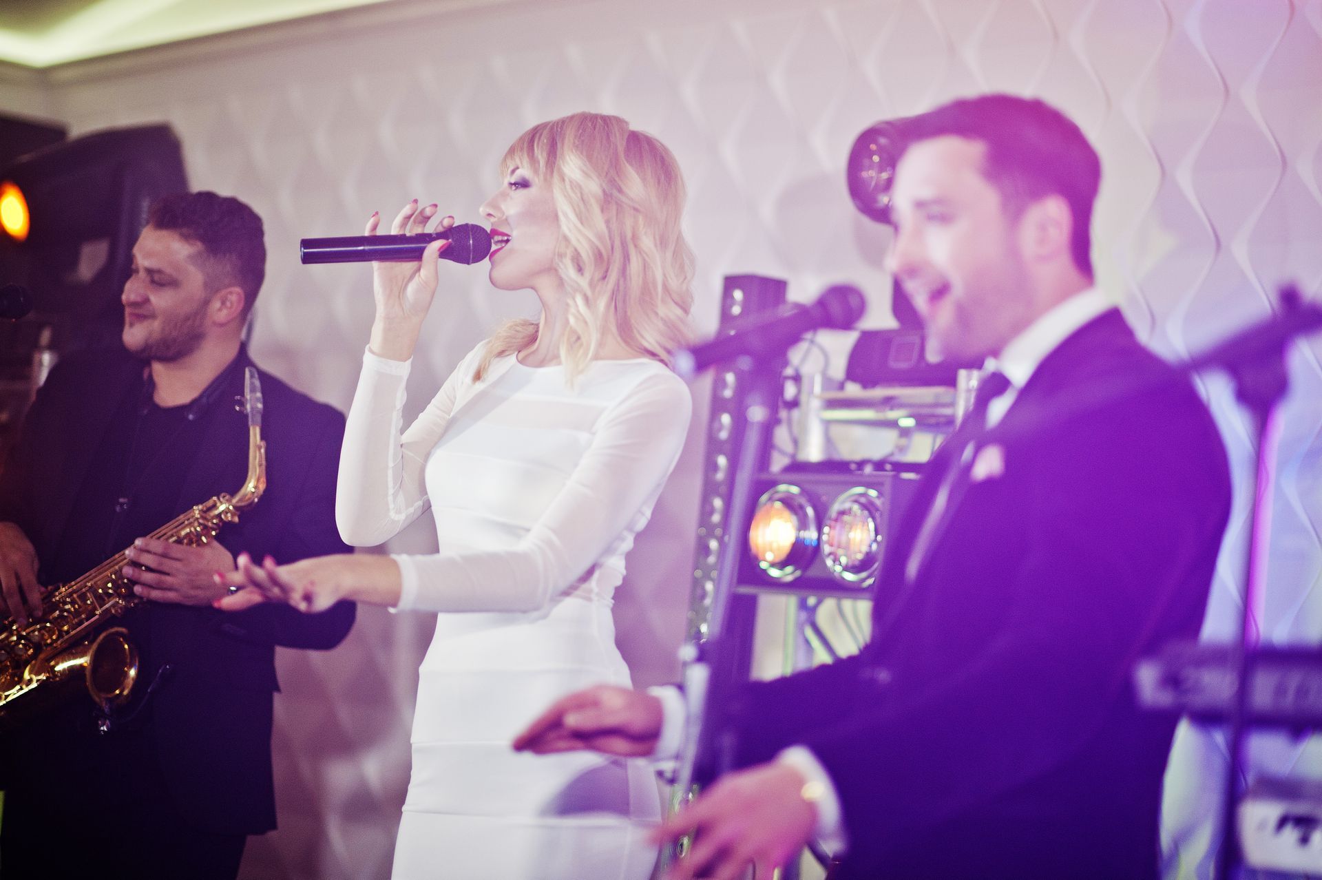 A female singer performing live with her band at a lovely wedding in Corsicana, Texas.