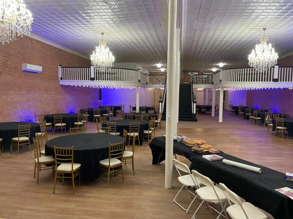 a large room with tables and chairs set up for a party .
